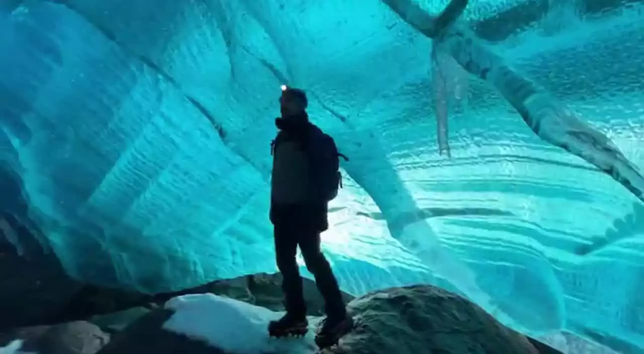 A street artist creating a massive chalk drawing on pavement, aerial view shows the incredible detail and scale. Time-lapse effect of the creation process.